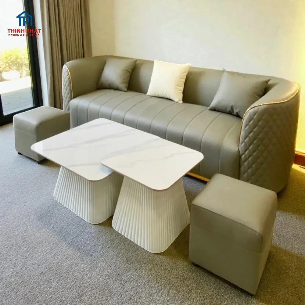 Sofa bo cong màu ghi viền champagne với phong cách soft luxury hiện đại tại showroom Thịnh Phát Đà Nẵng